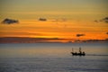 Colourful orange Cirrostratus cloudy tropical nautical sunrise seascape with fishing boat silhouette. Thailand