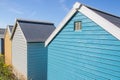 Colourful painted wooden beach huts or sheds with ventilation grill