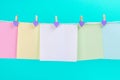 Colourful paper cards hanging rope isolated on blue background. Royalty Free Stock Photo