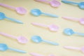 Colourful pastel utensil spoon and fork over bright yellow background