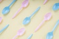 Colourful pastel utensil spoon and fork over bright yellow background