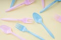 Colourful pastel utensil spoon and fork over bright yellow background