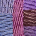 Different in color, size crocheted pieces are into one canvas as colourful abstract background