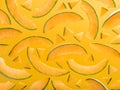 Colourful pattern made of ripe melon slices on yellow backdrop. Royalty Free Stock Photo
