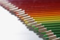 Colourful pencils set perfectly arranged in line on white surface Royalty Free Stock Photo