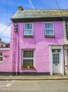 Colourful pink house along street in bright sunshine