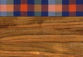 Colourful plaid napkin on walnut wooden floor table or cutting board