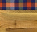 Colourful plaid napkin on walnut wooden floor table or cutting board