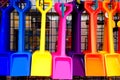 Colourful plastic shovels in shop.