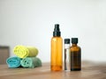 Colourful plastic transparent bottles for spa procedures at home and towels on wooden table. Recycling plastic bottles and flasks Royalty Free Stock Photo