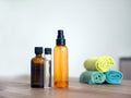 Colourful plastic transparent bottles for spa procedures at home and towels on wooden table. Recycling plastic bottles and flasks Royalty Free Stock Photo