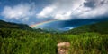 Colourful rainbow over a mountain valley Royalty Free Stock Photo