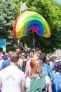 Colourful rainbow pride umbrella people walking in gay parade