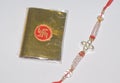 A colourful Rakhi and a golden packet