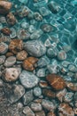 Colourful round sea pebbles in a blue sea. Royalty Free Stock Photo