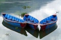 Colourful rowing boats on Phewa Lake, Pokhara, Nepal with mountains Royalty Free Stock Photo