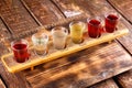 Colourful set of alcoholic cocktails in shot glasses shooters on wooden table for an alcoholic party Royalty Free Stock Photo