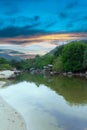 sunset and lush mountains in a fishing village Patong phuket thailand Long-tail boats and fishing timber huts long tail boats