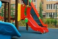 Colourful slide on outdoor playground for children in residential area Royalty Free Stock Photo