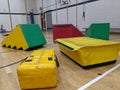 Colourful soft play equipment spread out across the gym floor with small boy in the background Royalty Free Stock Photo