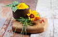 Colourful spices in bowls spilling onto an old aged scored wooden surface Royalty Free Stock Photo