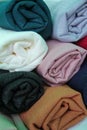 Colourful stack of folded fabrics, cloth, hijabs or scarves. Textile industry product photography Royalty Free Stock Photo