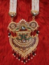 colourful stones golden necklace on red velvet background, Indian traditional jewellery