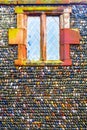 Colourful stones in lines in a concrete wall with a window at th Royalty Free Stock Photo