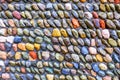 200 colourful stones lines in lines of ten in a concrete wall Royalty Free Stock Photo