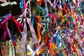 Colourful strings of ribbon tied to a fence. Royalty Free Stock Photo