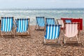 Colourful striped deck chairs on Brighton beach, England Royalty Free Stock Photo