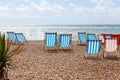 Colourful striped empty deck chairs on Brighton beach, England Royalty Free Stock Photo