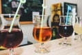 Colourful summer cocktails in glasses with straws. Drinks standing on the bar counter. Wine, pina colada and apple juice. Fresh Royalty Free Stock Photo