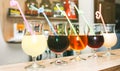 Colourful summer cocktails in glasses with straws. Drinks standing on the bar counter. Wine, pina colada and apple juice. Fresh Royalty Free Stock Photo