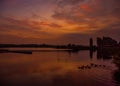 Colourful sunrise with swans and geese at Willen Lake, Milton Keynes