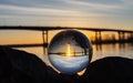 Clear globe in front of river and bridge Royalty Free Stock Photo