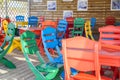 Colourful table and chairs ready for a cafe or restaurant. Summer terrace cafe, plastic colorful multi colored chairs outside. Co Royalty Free Stock Photo