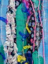 Colourful textured fabric strips sewn together. Textile art background.