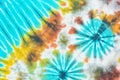 Colourful tie dyed pattern on cotton fabric background. Royalty Free Stock Photo