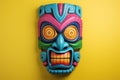 Colourful tiki mask on yellow background, created using generative ai technology