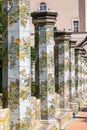 Colourful tiled pillars in the cloister garden at the Santa Chiara Monastery in Via Santa Chiara, Naples Italy.