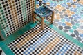 Colourful tiny wooden chair on a colourful squared floor in Arabian style