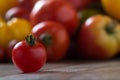 Colourful tomatoes on rustic background.
