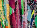 Colourful textured fabric strips sewn together. Textile art background.