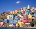 colourful town houses on a hill with the sea ocean water.