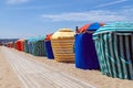 Colourful traditional beach huts on Deauville Trouville beach, Normandy, France.
