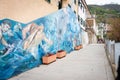 Colourful traditional mural on stone slab in street