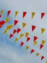 Colourful triangle flags hang on the rope on the street as festive decoration in Arrete, France