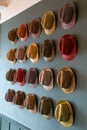 Colourful trilby hat collection, displayed on a wall