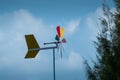 Colourful turbines on the sky and pine trees against the wind Royalty Free Stock Photo